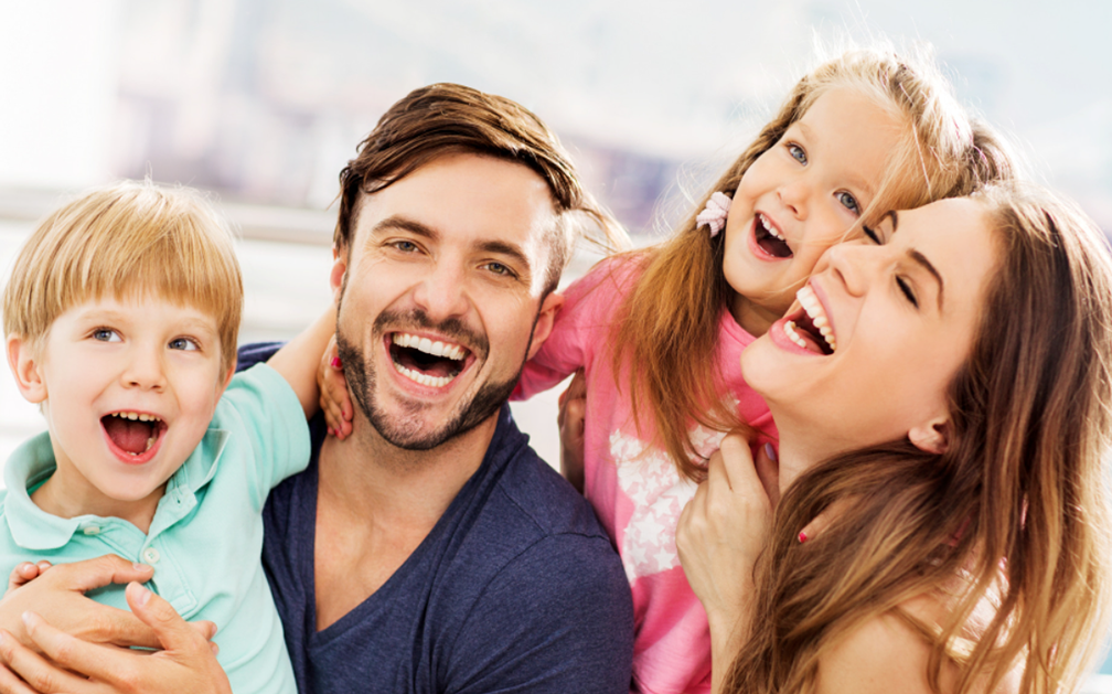 A Simple Guide to 30-Year Term Insurance. The image is of a smiling white family of four; a mom, a dad, a boy and a girl.
